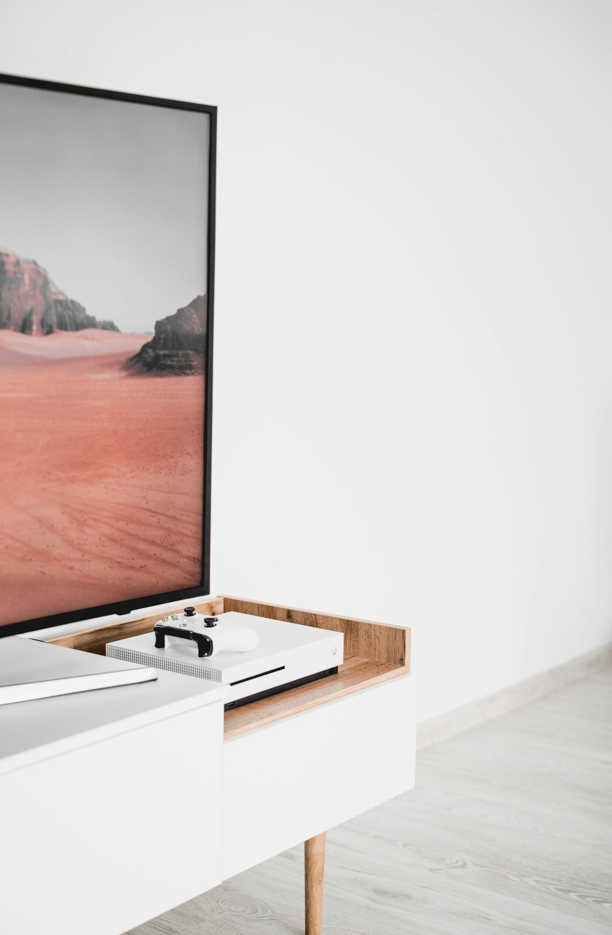 white Xbox One near TV
